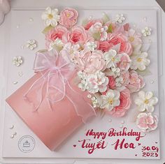 a birthday card with pink and white flowers in a gift box on top of a table