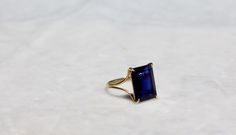 "A very high quality VVS1 dark blue iolite rectangle, emerald cut gem takes centerstage with this beautiful simple design. It's a modern/classic look that is very easy to wear and is sure to become one of your everyday ring. The shank is a split design, semi-rounded and 1mm thick. The size is 7. I ONLY MADE ONE BECAUSE THERE IS ONLY ONE OF THIS GEM IN THAT PARTICULAR COLOR AND SHAPE, BUT THIS RING CAN BE ADJUSTED TO ANY SIZE. PLEASE ALLOW A MINIMUM OF 3 WEEKS FOR ME TO RESIZE THE RING. IOLITE is Timeless Sapphire Jewelry With Radiant Cut, Formal Sapphire Ring With Radiant Cut, Formal Radiant Cut Sapphire Ring, Emerald Cut Tanzanite Sapphire Ring, Formal Sapphire Square Cut Rings, Formal Square Cut Sapphire Ring, Fine Jewelry Sapphire Rectangular Ring, Gift Emerald Cut Tanzanite Sapphire Ring, Modern Radiant Cut Sapphire Ring For Formal Occasions