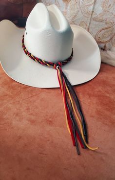 Custom Deerskin Braided Leather Hatband.  Deerskin is available in Turquoise, Natural, Light Brown, Saddle Brown, Red, Blue, Black, Gold, Grey, Whtie or Dark Brown.  Hatband is adjustable by sliding the bead at the end of the braid after the knots. These custom deerskin hats can be made from 1/4" or 1/8" deerskin.  I keep a lot of colors in stock, but others can be ordered.  Add your custom centerpiece.  Tell me what you want and let's created something together.   See my other hatbands:   https://www.etsy.com/shop/BlueEyesDesignsHB?ref=shop-header-name&listing_id=1476946144&section_id=31618272 See Custom Hat Band Listing:  https://www.etsy.com/listing/1239791038/custom-western-cowboy-cowgirl-hat-band?click_key=a8f27a46910e80585f9a75cc01cce729f063234b%3A1239791038&click_sum=98b927d5&ref=sh Red Adjustable Hat For Western-themed Events, Adjustable Multicolor Hat For Western-themed Events, Custom White Hat Bands, Custom White Hat Bands One Size Fits Most, Western Multicolor Hat Bands For Rodeo, Handmade White Hat Band For Western-themed Events, Handmade White Hat Bands For Western-themed Events, Handmade Multicolor Hats For Rodeo, Artisan Red Hat Bands For Festival