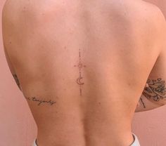 the back of a woman's upper body with tattoos on her left and right side