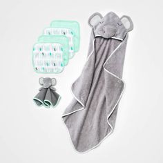 the baby's gift set includes an elephant blanket, bib and booties