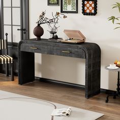 a black console table with two vases and an open box on it's top