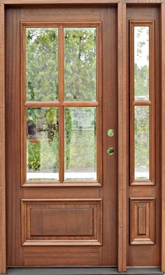 a wooden door with two sidelights and glass panes on the front entrance to a home