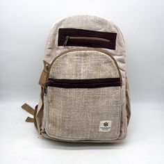 Introducing our handmade hemp backpack, a durable and eco-friendly option for carrying all your essentials. Crafted by skilled artisans, this backpack is made from high-quality hemp fiber and Heavy Duty Gheri Cotton fabric, known for its strength and durability. Not only is this backpack sturdy, but it also features a spacious interior with plenty of room for your laptop, books, and other daily necessities. The adjustable straps provide a comfortable fit, and the reinforced stitching ensures the backpack can withstand heavy use. But that's not all – our hemp backpack is also environmentally friendly. Hemp is a sustainable crop that requires minimal water and no pesticides, making it a popular choice for eco-conscious consumers. Plus, the backpack is handmade, so you can feel good knowing t Eco-friendly Handmade Backpack, Eco-friendly Brown Backpack, Eco-friendly Brown Backpack For Travel, Eco-friendly Brown Travel Backpack, Casual Natural Color Standard Backpack, Eco-friendly Everyday Backpack In Natural Color, Eco-friendly Travel Backpack, Eco-friendly Backpack For Everyday Use, Eco-friendly Brown Backpack For Everyday