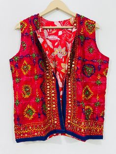 Fulkari open vest is made from a soft traditional indian phulkari handmade scarf. the scarves are used for festive occasions like weddings. the phulkari scarf is hand embroidered and embellished by indian artisan. vest has long wide vest coat. the vest jacket has an open front, and the length is normal jacket. indian chanderi silk phulkari hand work boho fashion kimono robe jacket. indian embroidered boho style beach wear body cover up. reversible vest jackets/coat you can wear this one in both side one side is phulkari embroidered and other side is cotton printed. *buy it for the holidays! looks fabulous over a long silk tank dress or palazzo pants. or wear it with to install jeans and boots. measurements: colour: as per the picture approx length : 23 inch / 60 cm bust approx : 40 inch / Bohemian Traditional Wear With Handwork For Festive Occasions, Bohemian Traditional Wear For Puja Festivals, Bohemian Traditional Wear With Handwork For Diwali, Festive Bohemian Vest, Bohemian Embroidered Choli For Festivals, Bohemian Chanderi Choli For Festivals, Bohemian Traditional Wear With Pallu For Festival, Bohemian Festival Vest, Bohemian Choli With Dupatta For Festival