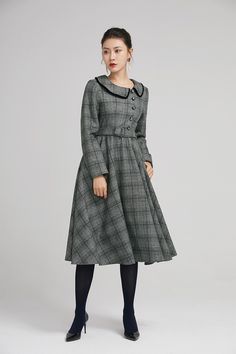 "Simple. With its pleated skirt and grayscale plaid pattern, this vintage wool dress epitomizes classic styling. She's all class and quality with no bells or whistles. Near-perfect vintage condition, designed with lapel collar, long sleeves and tie belt waist, it will be your favorite one of your wardrobe. Details: * 35% wool blend, 35% fiber and polyester, 30% nylon * Polyester lining * long sleeves * tie belt waist * lapel collar * button decoration in front * knee length * back zipper closure Classic Vintage Dress For Work In Fall, Classic Vintage Dress For Fall Workwear, Classic Fall Vintage Dress For Workwear, Classic Vintage Fashion Dresses For Fall, Vintage Plaid Dress For Winter, Retro Plaid Winter Dresses, Vintage Plaid Winter Dress, Formal Long Sleeve Vintage Dress For Fall, Elegant Midi-length Plaid Dress For Fall