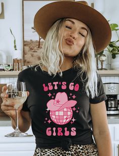 Get ready to be OBSESSED with your new "Let's Go Girls" western graphic tee. It's the cutest and most trendy way to emit all those important country western vibes! This T-shirt makes the perfect bachelorette party, birthday party or concert tee! Find the matching "Man I Feel Like a Bride" shirt here: https://www.etsy.com/listing/1443816374 DETAILS * Bella + Canvas Unisex Premium T-Shirt  * Soft and lightweight  * 100% combed and ring-spun cotton  * Athletic Heather is 90% combed and ring-spun co Cute Party T-shirt With Text Print, Party T-shirt With Funny Print, Cute Fitted Party T-shirt, Cute Party Shirt With Graphic Print, Cute Graphic Print Shirt For Party, Disco Bridal Party, Bachelorette Disco, Nashville Bachelorette Party Shirts, Vegas Birthday