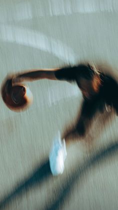 a blurry photo of a person running with a frisbee in their hand