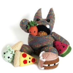 there are knitted toys in the shape of animals and food items on the floor