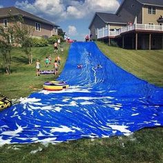 an inflatable water slide is being pulled down the hill