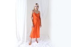 * Stunning 90s silk slip dress * Acquired from a closing silk importer and is unworn old stock * Bias cut * Adjustable spaghetti strap * Stunning tangerine colour * Lightweight silk, very lightly sheer SIZING: I have 3 sizes available, a limited number of each. Small, Medium & Large. Cindy is wearing the Medium. MEASUREMENTS [Taken laid flat, keep in mind the fluid cut has a lot of give]: Small: Underarm - Underarm: 40cm // Waist: 35cm // Hips: 49cm // Length: 125cm Medium: Underarm - Underarm: Fitted Orange Slip Dress For Spring, Spring Evening Orange Slip Dress, Fitted Sleeveless Orange Slip Dress, Fitted Orange Sleeveless Slip Dress, Sleeveless Orange Slip Dress For Spring, Orange Sleeveless Slip Dress For Spring, Tangerine Color, Silk Slip Dress, Silk Slip