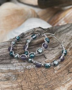 These fun, beachy boho small hoop threader earrings are hand knotted onto champagne silver waterproof cord with  frosted sugar plum,  lustered teal and galvanized blue slate Toho seed beads.  The threader hoops measure approximately 30mm  (1 1/8 in length and 1 1/8 wide) You can view the last photo to see the size.   Stainless steel and nickel free. These earrings are so lightweight making them perfect for sensitive ears.   Your earrings will arrive packaged in an organza bag, ready for gift giving.  If you would like a tiny gift card attached with a special message, please include message at checkout in the "note to seller" section, which is located in your cart.  Come visit my shop at www.etsy.com/shop/thatshowiknot Follow me on FB and Instagram where I often post new designs first.  @th Macrame Hoop Earrings, Bead Macrame, Macrame Hoop, Tiny Gifts, Beachy Boho, Small Boho, Sugar Plum, Threader Earrings, Sensitive Ears