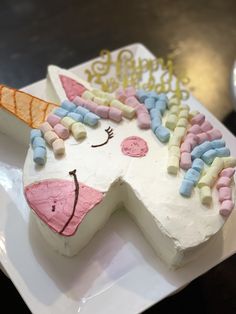 a cake shaped like a unicorn on a plate