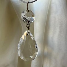 an image of a necklace that is hanging on a curtain