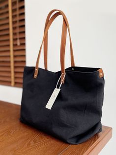 Overview： Design: Women Canvas Large Shopper Tote Bag Black Canvas Tote Shoulder Bag Handbag for MensIn Stock: Ready to Ship (2-4 days)Include: Only BagCustom: NoColor: Black Leather: CanvasMeasures: 46cm x 32cm x 15cm Weight: 0.45kgSlots: 1 zipper slot, 1 phone slot, 1 wallet slot, Accessories(option): NoneStyle: Women Canvas Large Shopper Tote Bag Black Canvas Tote Shoulder Bag Handbag for MensVery durable (At least 5 Years) and it should last a life time Description: The Women Black Canvas Large Shopper Tote Bag is the epitome of practicality and style, designed to accompany you seamlessly through your daily adventures. Crafted from durable black canvas, this tote bag boasts a generous size of 46cm x 32cm x 15cm, providing ample space to carry all your essentials and more. Whether you'r Classic Black Rectangular Canvas Bag, Black Rectangular Satchel With Canvas Lining, Casual Black Canvas Bag For On-the-go, Classic Black Canvas Bag, Black Canvas Satchel With Canvas Lining, Black Rectangular Canvas Bag With Canvas Lining, Black Bucket Shoulder Bag With Snap Closure, Classic Black Canvas Shoulder Bag, Classic Black Canvas Satchel