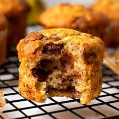 a muffin on a cooling rack with other muffins in the background