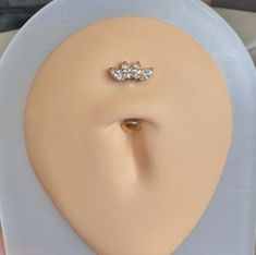 a pair of nose piercings on top of a mannequin's head