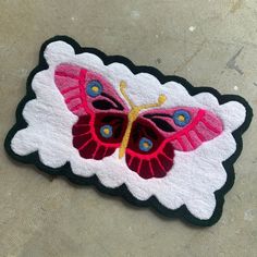 a patch with a pink butterfly on it