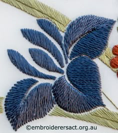 an embroidered design with blue leaves and red flowers