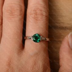 It is a lab emerald ring. The main stone is 7 mm*7 mm round cut.weight about 1.30 carats. The basic metal is sterling silver and plated with rhodium/14k white gold/14k rose gold/14k yellow gold You can also go to my shop Home for more elegant rings: https://www.etsy.com/shop/godjewelry?ref=hdr_shop_menu Customization is always welcome and please feel free to contact with me if you have any design ideas! May Birthstone Ring With Bezel Setting, Minimalist Emerald Birthstone Ring For Anniversary, Anniversary White Gold Emerald Ring With Bezel Setting, Emerald Jewelry With Bezel Setting In Round Band, White Gold Emerald Ring With Bezel Setting As Gift, Bezel-set May Birthstone Jewelry, Sterling Silver Emerald Ring With Bezel Setting, Emerald Bezel Setting Birthstone Ring For Anniversary, Emerald Solitaire Promise Ring