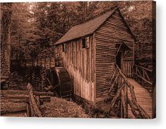 a sepia photograph of a wooden cabin in the woods