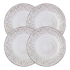 set of four white dinner plates with intricate designs on the rim and sides, each plate has