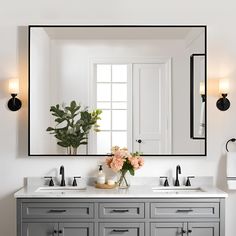 a bathroom vanity with two sinks and a large mirror above it, along with a potted plant