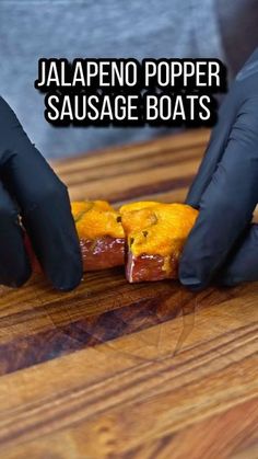 someone in black gloves is preparing food on a cutting board with the words jalapeno popper sausage boats