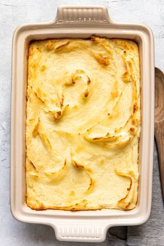 a square casserole dish filled with mashed potatoes