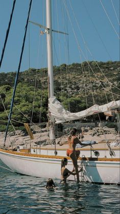 two people and a dog on a boat in the water