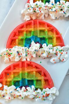 two rainbow waffles with marshmallows on them