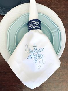 a napkin with a snowflake design on it sitting on top of a plate