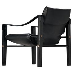 a black leather chair with arms and legs