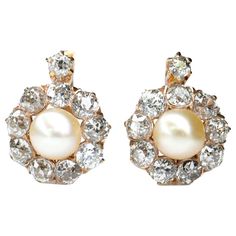 An adorable pair of cluster earrings feature lustrous natural pearls wrapped with a scalloped diamond border in 18 karat yellow gold. Sweet as can be. Circa 1900. Perfect Condition Diamond: 2.1ct Weight: 4.7g Length: 18mm Width: 12mm Size of pearl: 6mm We have many other fantastic pieces of antique and vintage jewelry listed on our 1stDibs store, so please consider browsing our other pieces. Vintage Diamond Earrings, Gold Collar Necklace, Diamond Cluster Earrings, Platinum Earrings, Pearl And Diamond Earrings, Diamond Brooch, Gold Pearl Earrings, Silver Tops, Natural Pearl