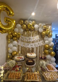 a birthday party with balloons, cake and desserts