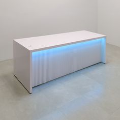 a white bench with blue lights on it in the middle of a floored room