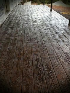 an outdoor deck with wood planks and railing