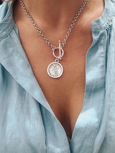 🌟 Bestseller 🌟 A stylish, lightweight edgy matte silver medallion style necklace. Perfect for layering with other chains.🗿Matte Silver, zamak rolo chain🗿 Matte Silver zamak Greek coin medallion (double sided) 25mm x 20mm🗿Large front facing toggle clasp🗿 Wear on it’s own or layer it up🗿 Choose your length 🌟 Zamak is that stylish matte silver metal favoured by European designers and has a distinctly bohemian character. It is a mix alloy of zinc, aluminium, magnesium and copper that is dipp Coin Necklace Silver, Chain Layering, Silver Coin Necklace, Toggle Necklace, Greek Style, Medallion Necklace, Coin Jewelry, Fabulous Jewelry, Necklace Boho