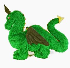 a green stuffed animal that is laying down