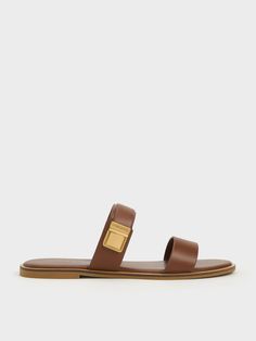 A softer alternative to black, this iteration of the Dove sandals are key to elevated casual style. With a minimalist double-strap design in a luxurious dark brown finish, these sandals will go well with most outfits while still looking sophisticated. Gold-toned snap buckles add shine and ensure a secure feet - they are the standout details of these versatile shoes. From its breathable, easy-to-wear design to its classic good looks, these sandals offer great style mileage. Classic Double Strap Sandals With Leather Footbed, Chic Brown Sandals With Adjustable Strap, Modern Brown Open Toe Footbed Sandals, Modern Brown Sandals With Adjustable Strap, Modern Brown Footbed Sandals For Summer, Modern Brown Flat Sandals, Modern Brown Flat Slides, Brown Double Strap Slides For Spring, Modern Brown Double Strap Sandals