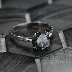 a diamond ring sitting on top of a wooden table