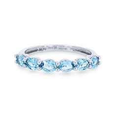 a white gold band with blue topaz stones