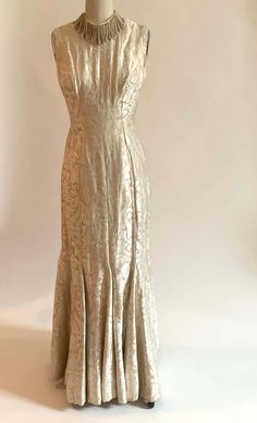 For Sale on 1stDibs - Stunning vintage 1960s sleeveless fluted gown and coat set set in cream and pale gold brocade. Gown has a beautiful fit and flare shape with a deep scoop Gold A-line Fitted Evening Dress, Champagne A-line Fitted Gown, Fitted Brocade Evening Dress For Formal Occasions, Fitted Brocade Evening Dress For Gala, Formal Fitted Brocade Evening Dress, Elegant Brocade Gown With Fitted Bodice, Gold Fitted A-line Evening Dress, Fitted Brocade Gown For Formal Occasions, Formal Fitted Brocade Gown