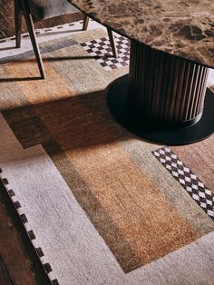 an area rug that has been placed on the floor in front of a round table