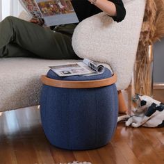 a person sitting on a chair reading a magazine