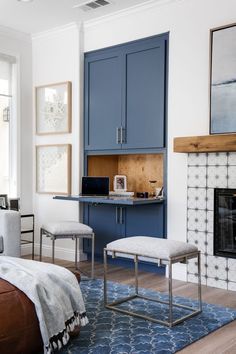 a bedroom with blue cabinets and a fireplace