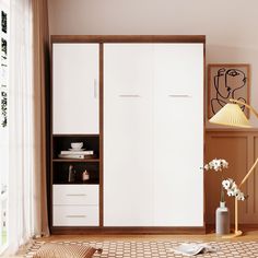 a living room with an armoire and white furniture