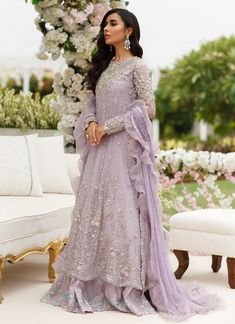 a woman in a lavender colored gown