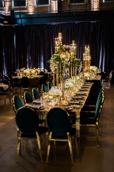 a long table is set up with candles and centerpieces for an elegant dinner