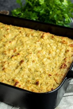 cornbread dressing in a black casserole dish on a white cloth with text overlay